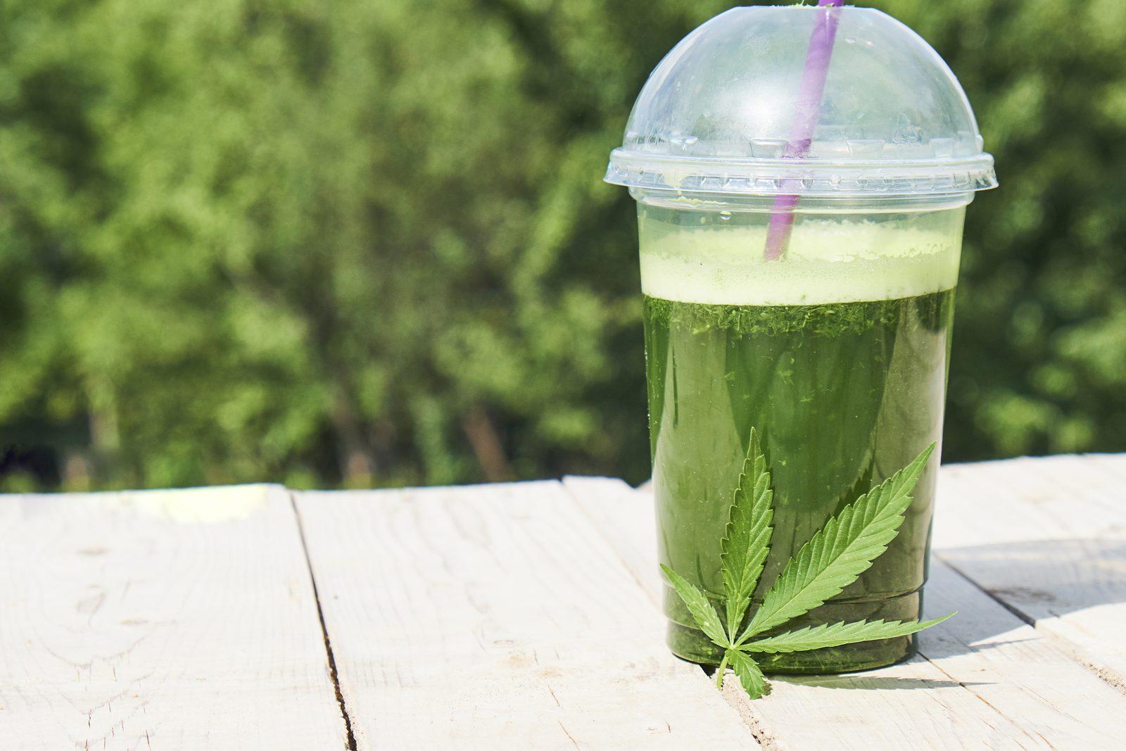 Green drink on white table with green background